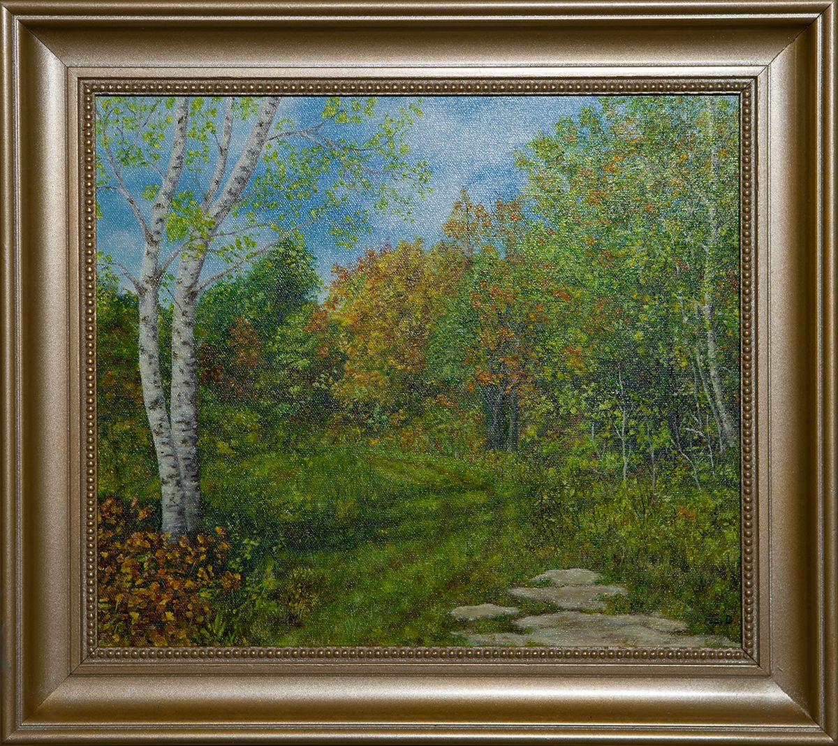 Early autumn woods: white birches on the left, trees turning orange and gold, and a path of flat stones leading through green grass.