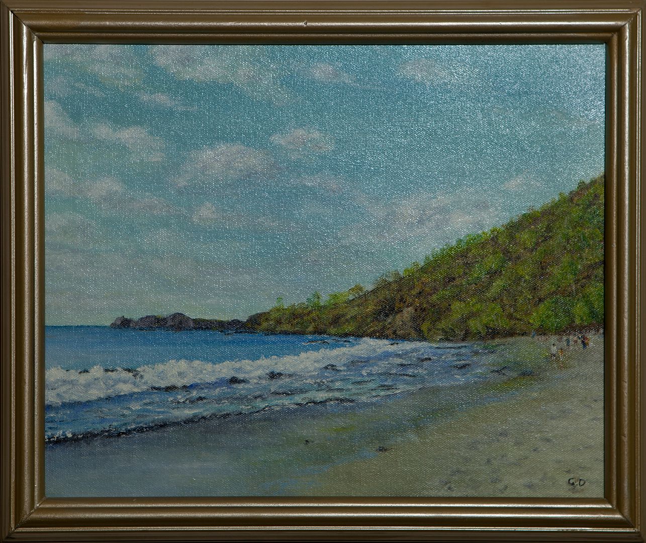 A sandy beach with waves rolling in, curving toward a wooded headland under a sky of soft white clouds; a few small figures walk along the shore.